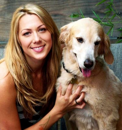 Colbie Caillat with her Golden Retriever sitting beside her
