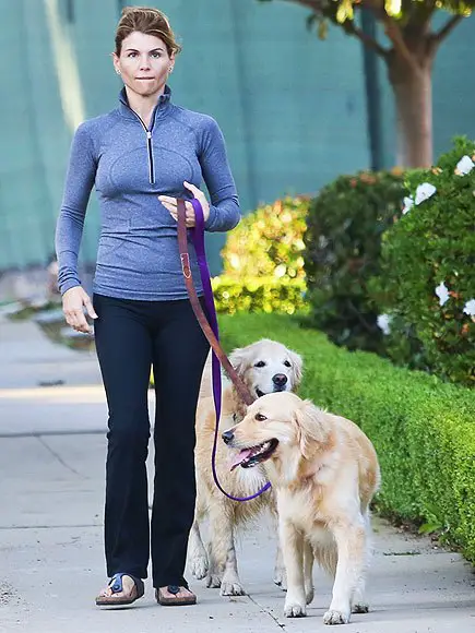 Lori Loughlin taking her two Golden Retrievers for a walk outdoors
