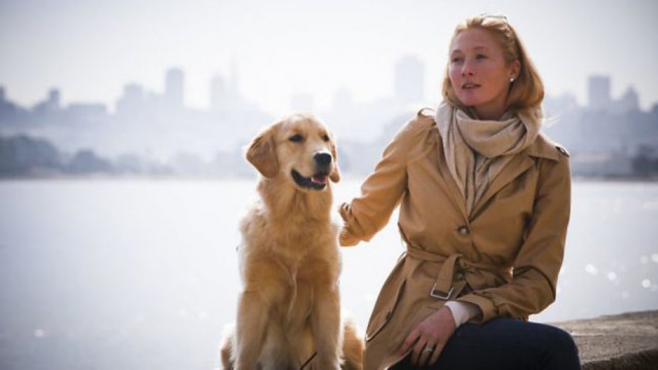 Maggie Rizer sitting on the bench with her Golden Retriever