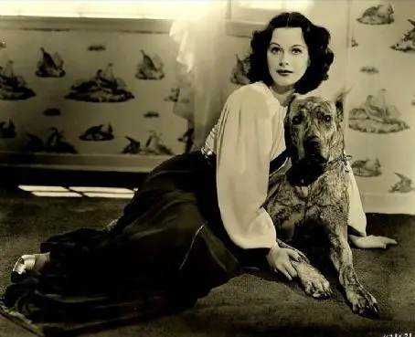 Hedy Lamarr sitting on the floor with her Great Dane