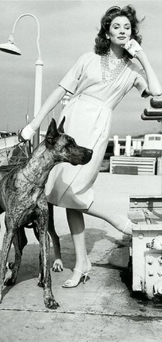 Suzy Parker standing at the port next to her Great Dane