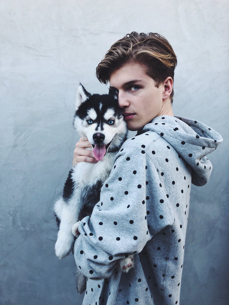 Alex Lange holding his husky puppy