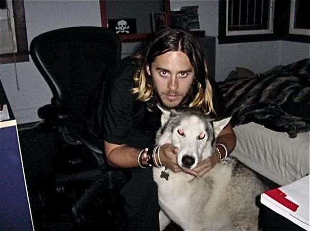 Jared Leto sitting on the chair while hugging his Husky from behind