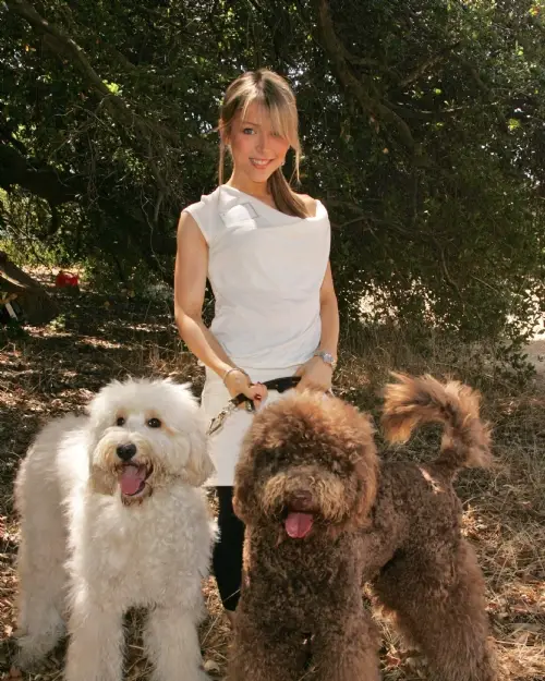 Ashley Peldon in the forest with her three Labradoodles.