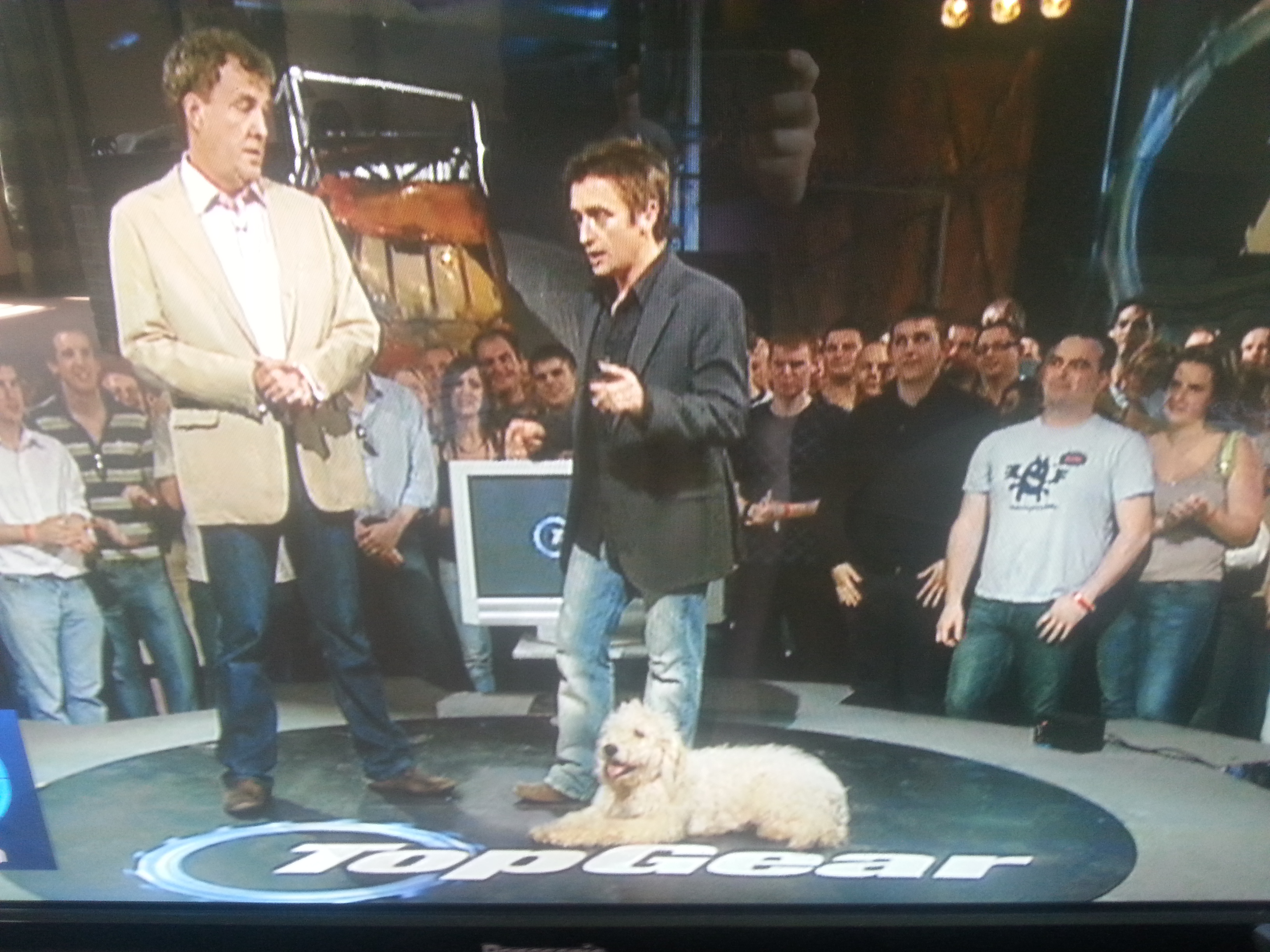 Jeremy Clarkson on a show with his Labradoodle lying on the floor