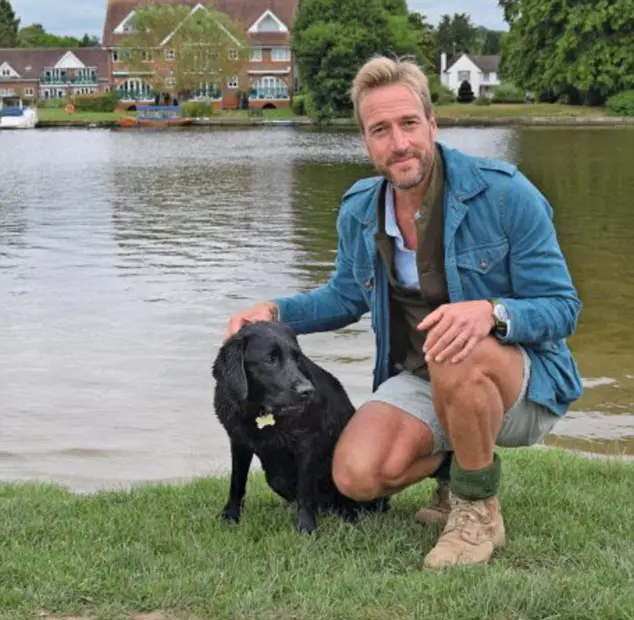Ben Fogle by the lake with his wet Labrador Retriever