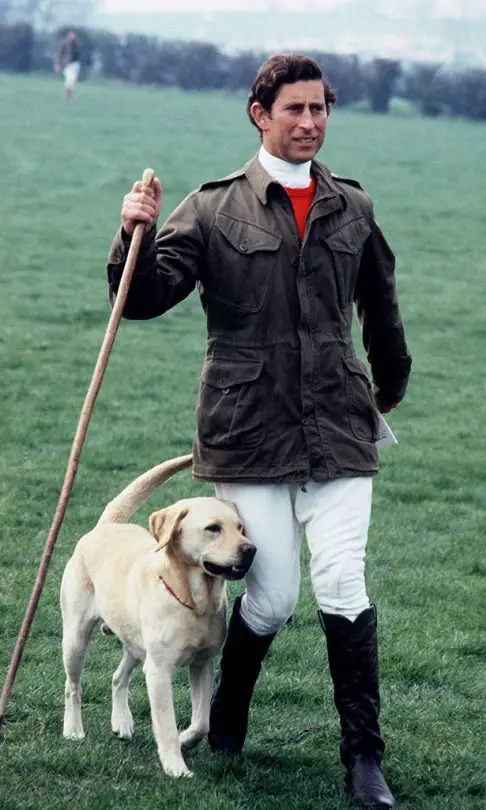 Prince Charles walking in the yard with his Labrador Retriever