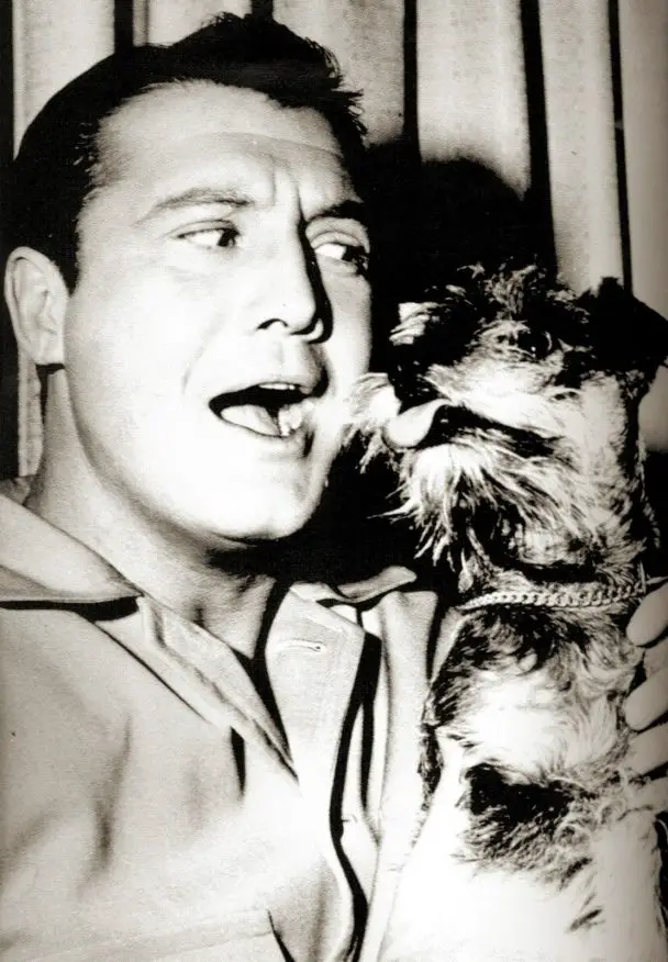 George Reeves playing with his Schnauzer dog