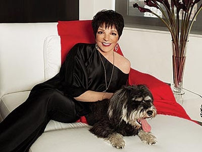 Liza Minnelli sitting on the sofa with her Schnauzer