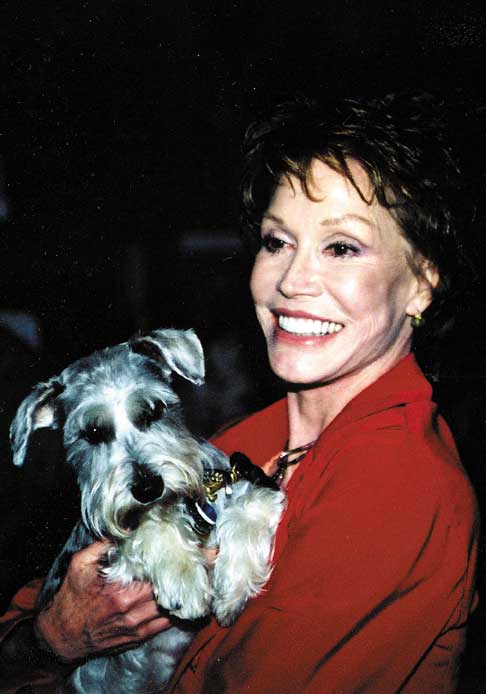 Mary Tyler Moore carrying her Schnauzer