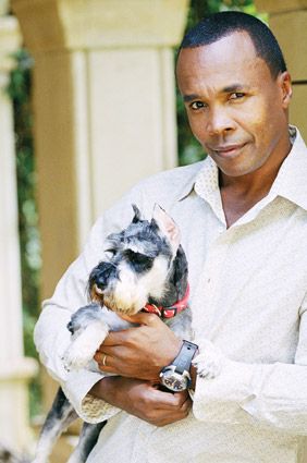 Sugar Ray holding his Schnauzer dog