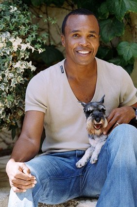 Sugar Ray sitting in the garden with his Schnauzer in his lap