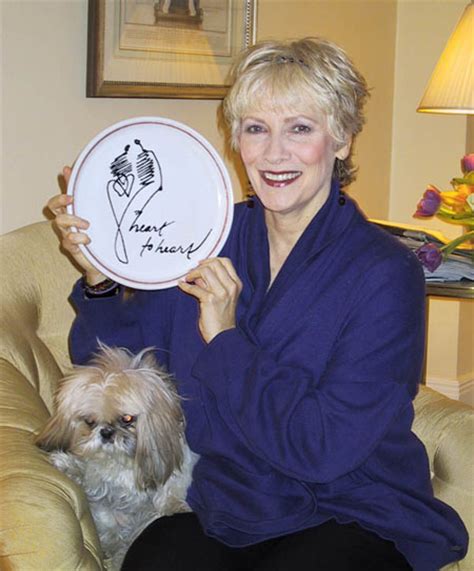 Betty Buckley sitting on the sofa with her Shih Tzu