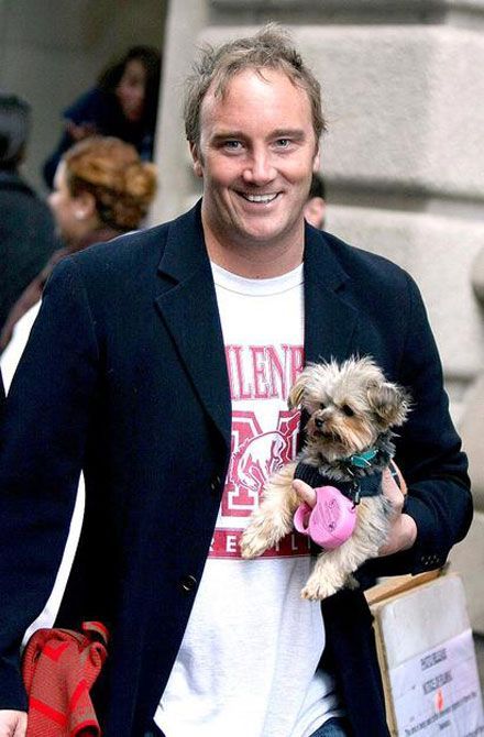 Jay Mohr walking while carrying his Yorkshire Terrier in his one arm