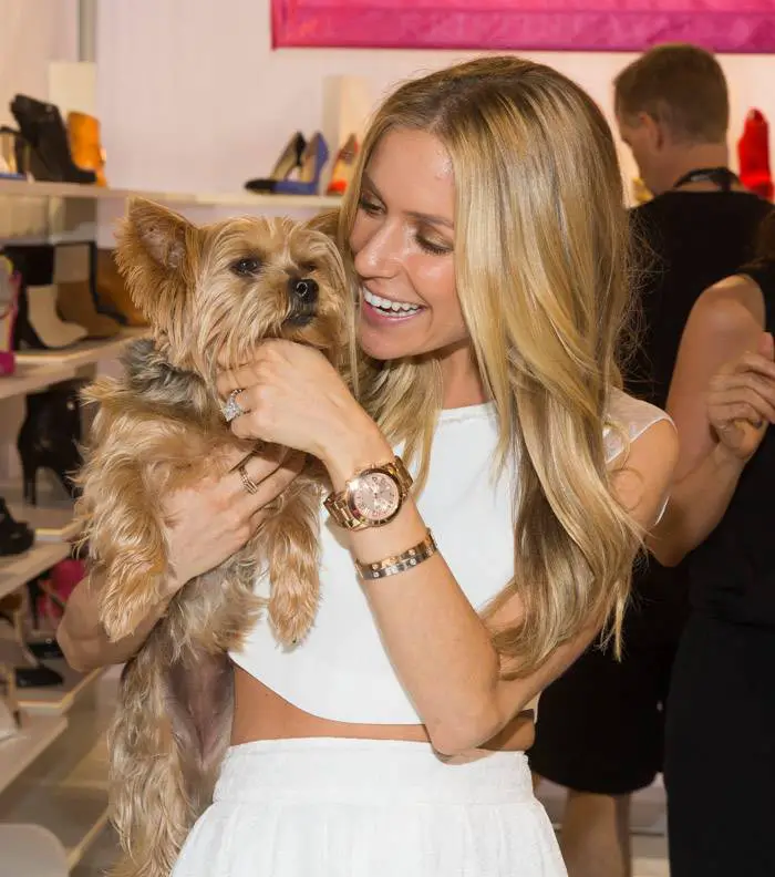 Kristin Cavallari carrying and happily talking to her Yorkshire Terrier