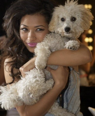 Vanessa White hugging her Bichon Frise close to her face