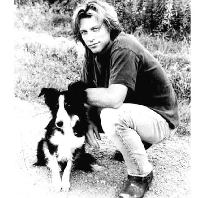 black and white photo of Jon Bon Jovi with his Border Collie dog 
