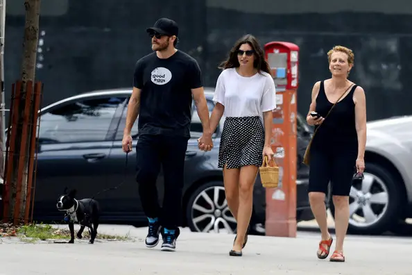 Jake Gyllenhaal walking his Boston Terrier in the street
