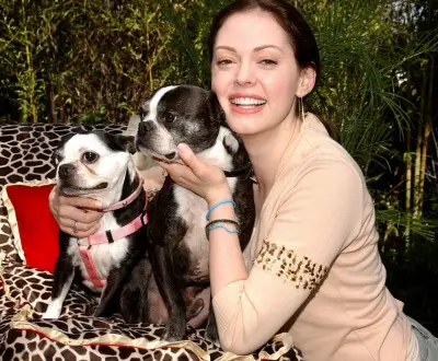 Rose McGowen hugging her two Boston Terriers