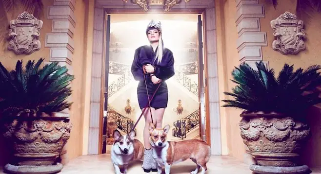 Lily Allen standing in the front door with her two Corgis