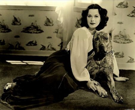an old photo of Hedy Lamarr sitting on the floor with her Great Dane dog