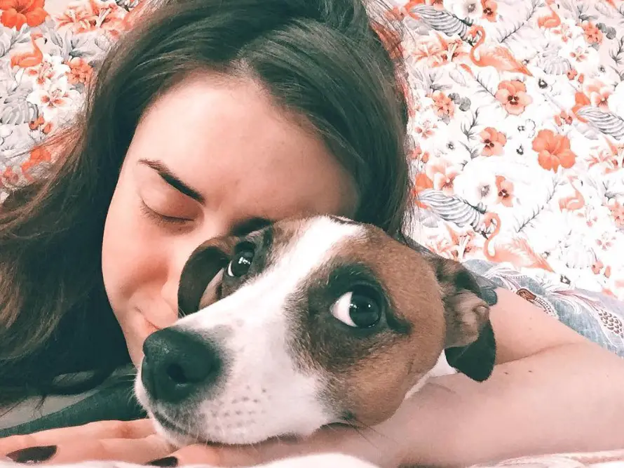 a woman hugging a Jack Russell