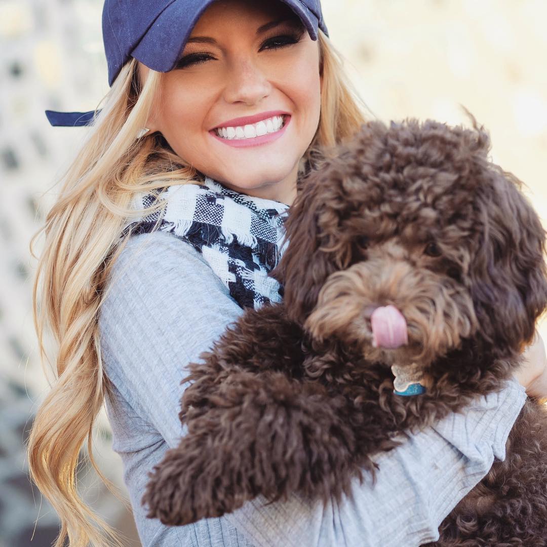 Jenny Delaney holding her labradoodle puppy