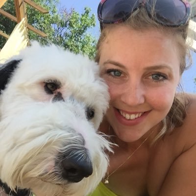 Kristin Collins taking a selfie with her labradoodle
