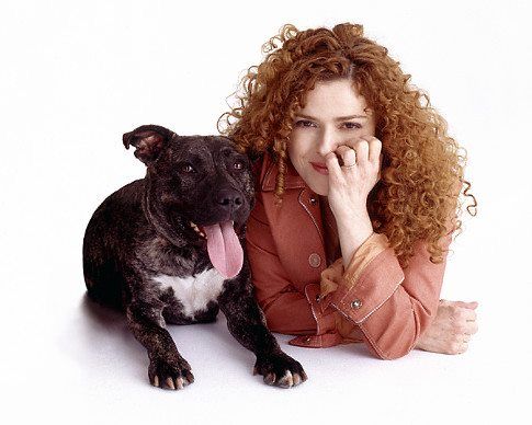 Bernadette Peters on the floor with its Pit Bull dog