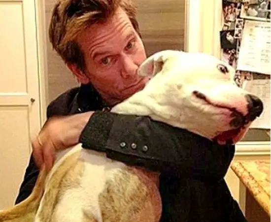 Kevin Bacon hugging his Pit Bull dog