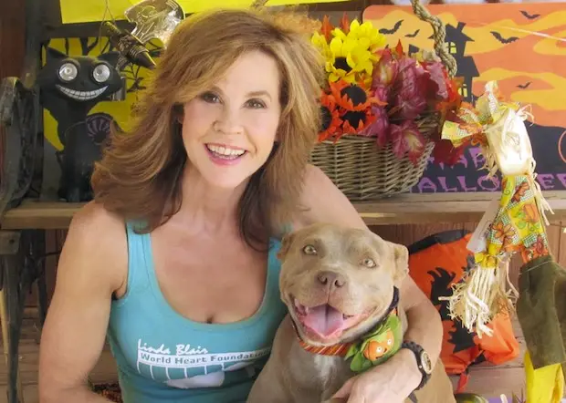 Linda Blair sitting with her Pit Bull beside her
