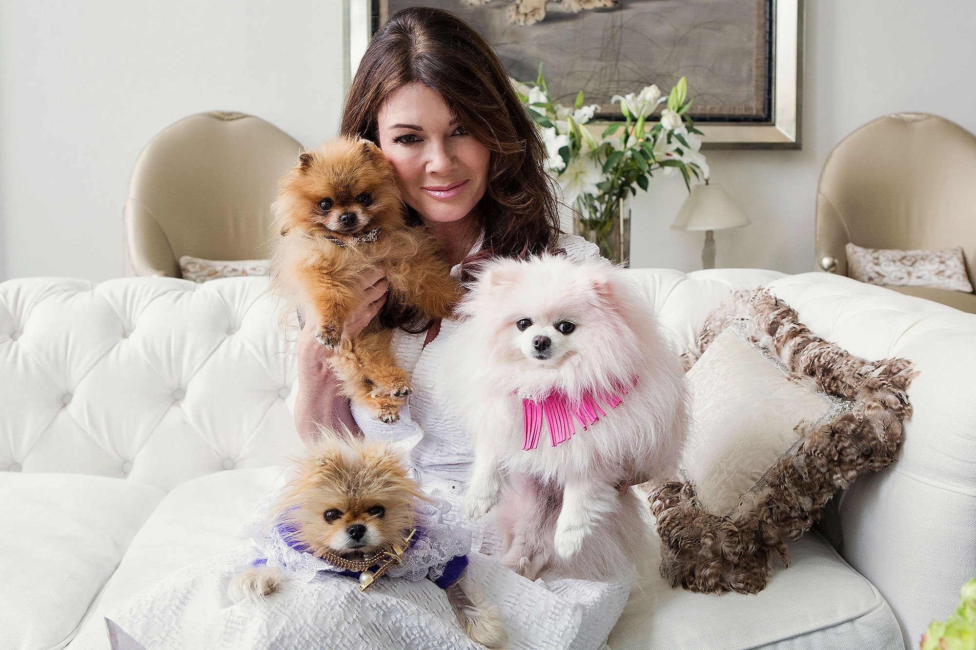 Lisa Vanderpump sitting on the sofa with her three Pomeranians
