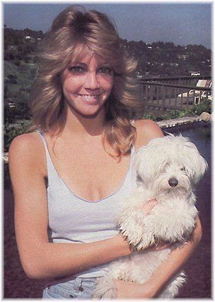 Heather Locklear standing at the hill top balcony while holding her Maltese.