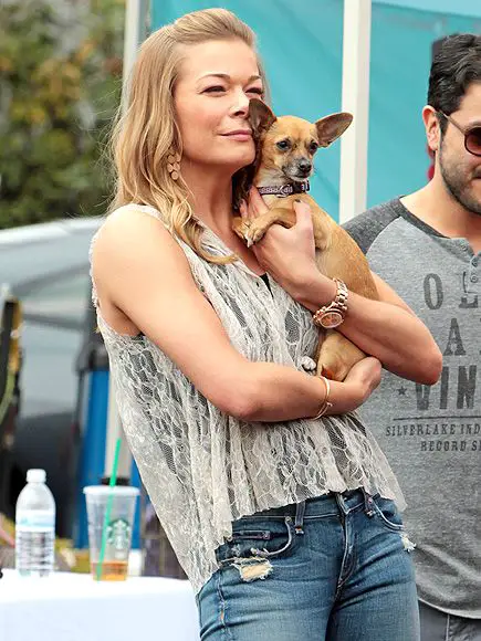 Leann Rimes holding her Chihuahua close to her face
