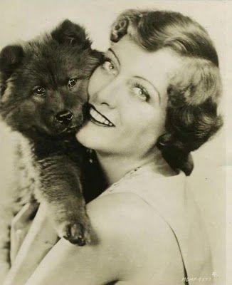 Joan Crawford hugging a chowchow puppy