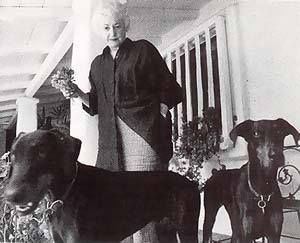Beatrice Arthur in the front porch with her two Dobermans
