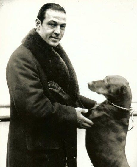 Bela Lugosi with his Doberman standing up and leaning towards him