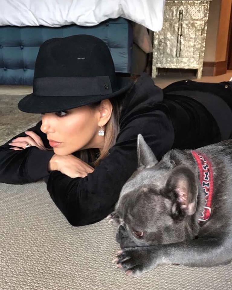 Eva Longoria lying on the floor next to a French Bulldog