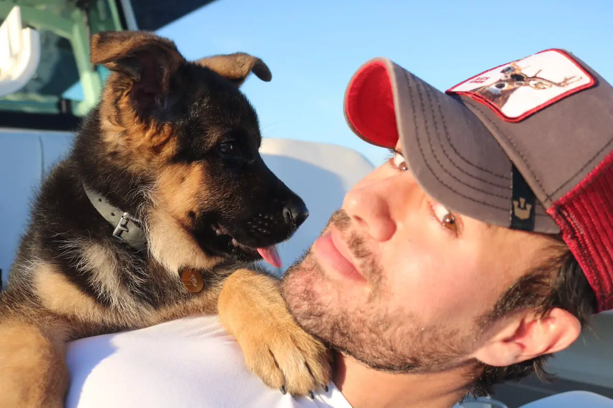 Enrique Iglesias with his German Shepherd puppy lying on top of his chest