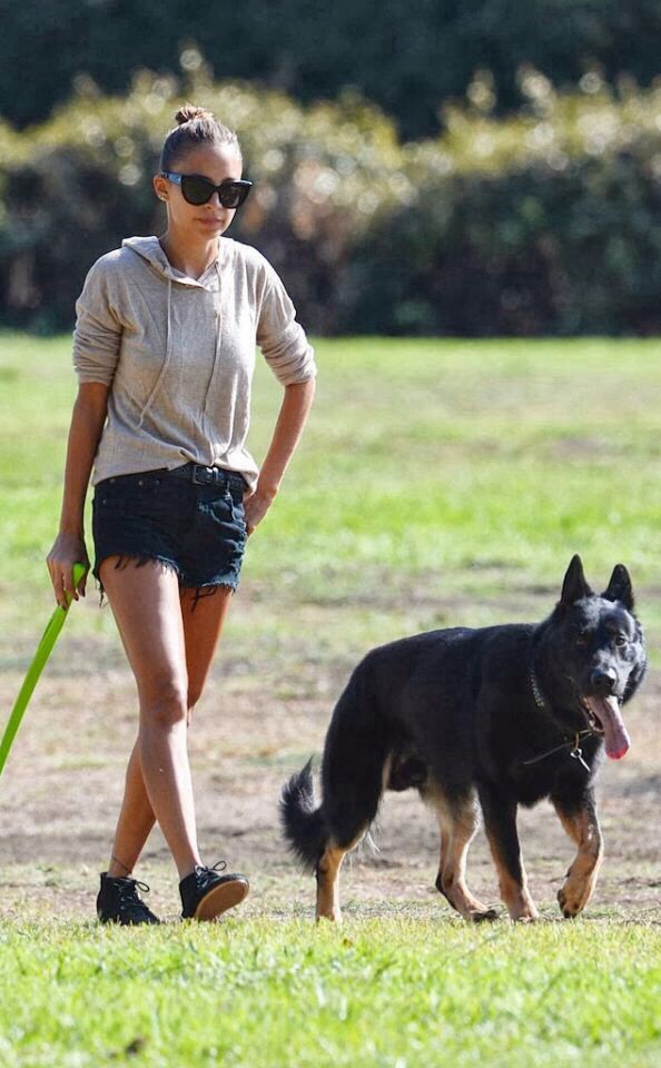Nicole Richie walking at the park with a German Shepherd
