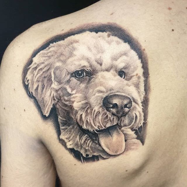 3D smiling Labradoodle with its tongue out tattoo on the back