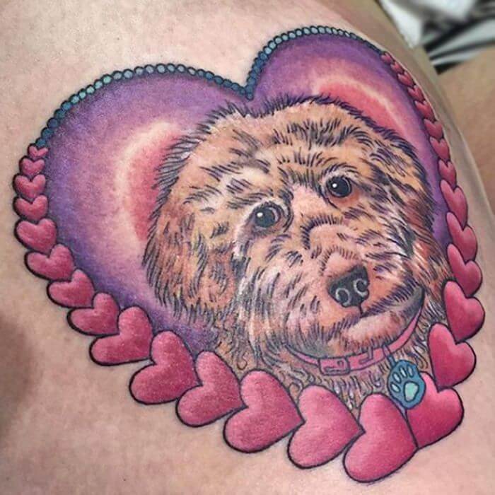 A Labradoodle inside a pink and lavender heart tattoo