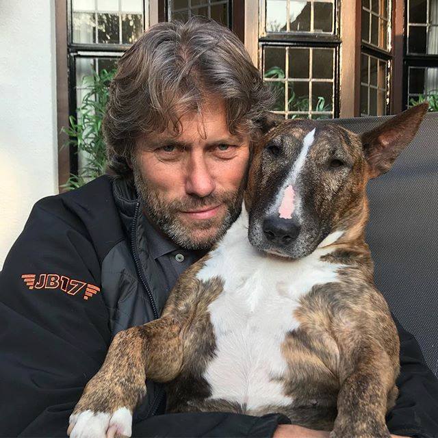 John Bishop hugging his Bull Terrier