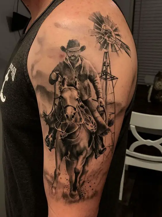a black and gray man riding a Horse tattoo on the shoulder