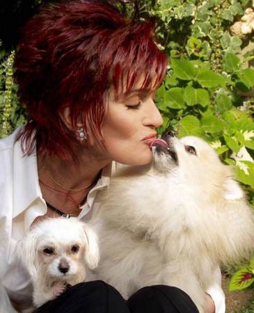 Sharon Osbourne with her Pomeranian licking her mouth