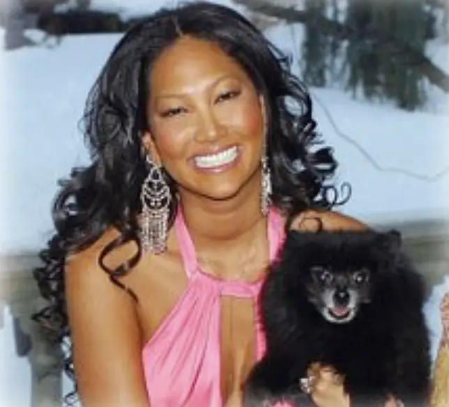 Kimora Lee Simmons holding her black Pomeranian