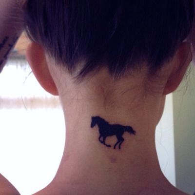 a small silhouette of a Horse tattoo on the nape of a woman