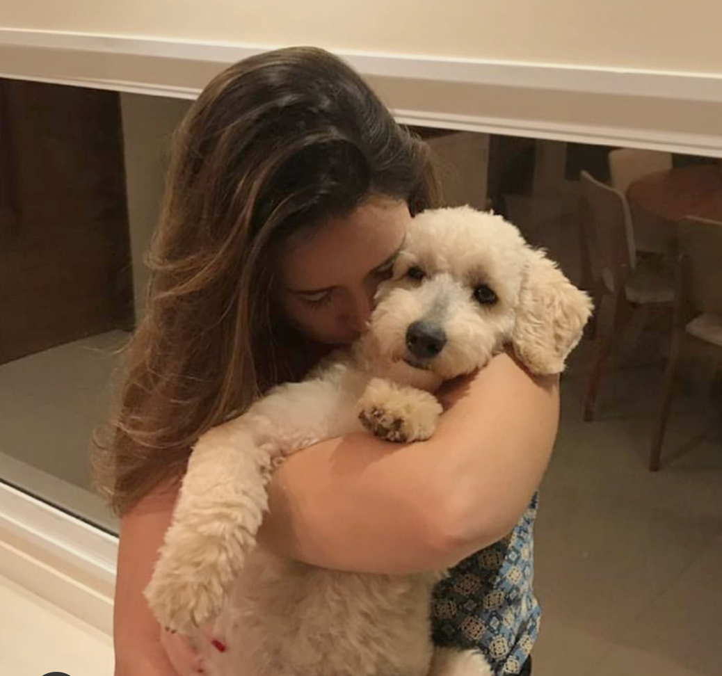 a woman hugging a Poodle