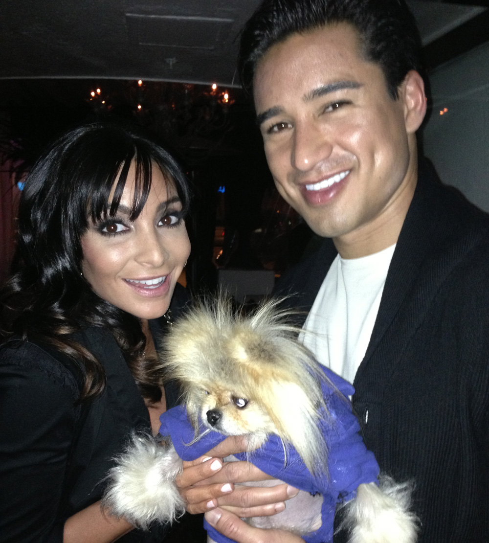 Mario Lopez with a woman and their Pomeranian
