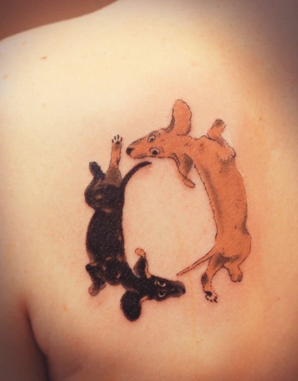 two animated Dachshund with their bodies stretched out forming a circle together tattoo on the back